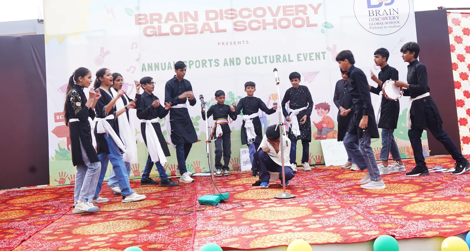 A student crouches with his head in his hand as the cast dances around him