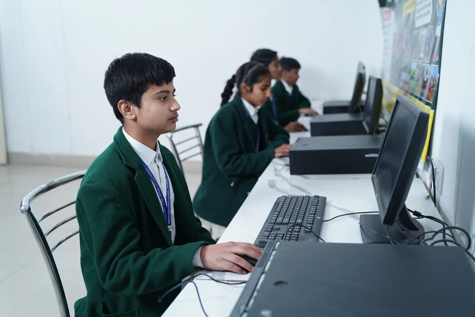 Students at computers in the school lab